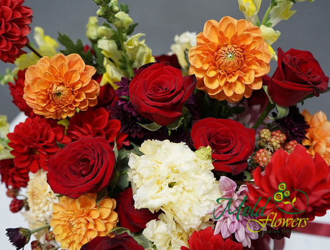 Box with red roses, dahlias, and eustoma photo